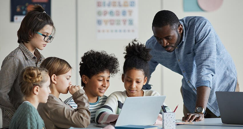 Photo of a man teaching children